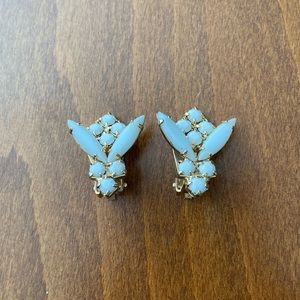 White milk glass clip earrings, floral or bee design. Gold tone back and clips.